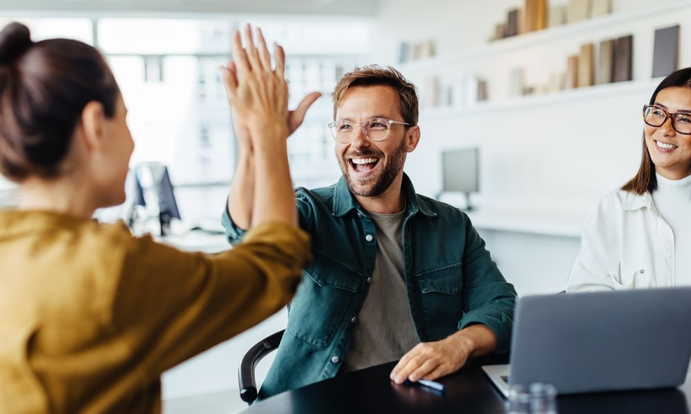 Two Colleagues Giving Each Other A High-Five