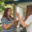 Two neighbors engaged in a heated argument outdoors. Neither one backing down due to pride, believing they are correct.