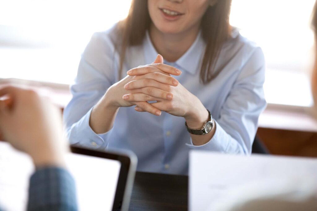 Smiling woman listening attentively to colleagues